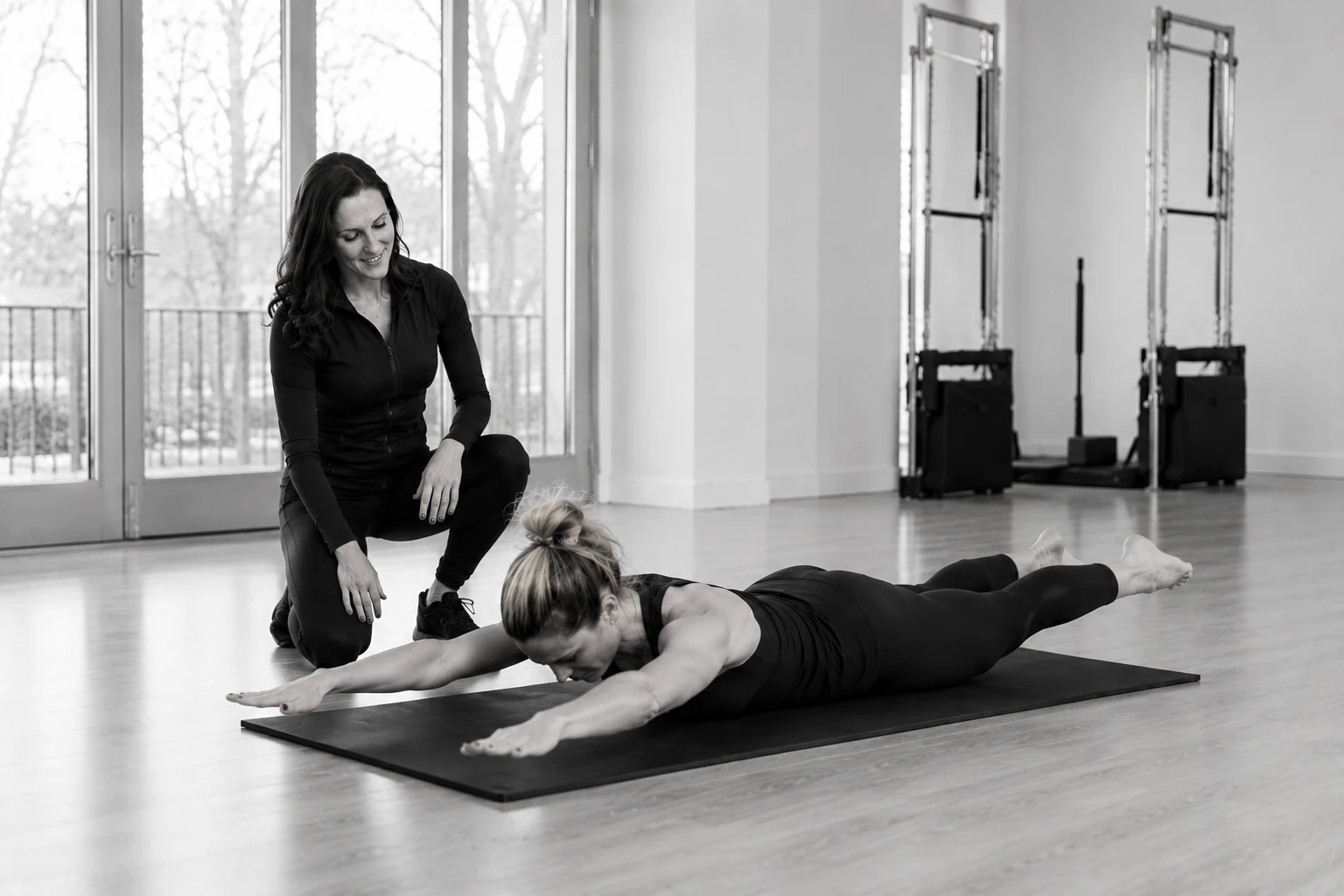 Cara teaching a client on the mat